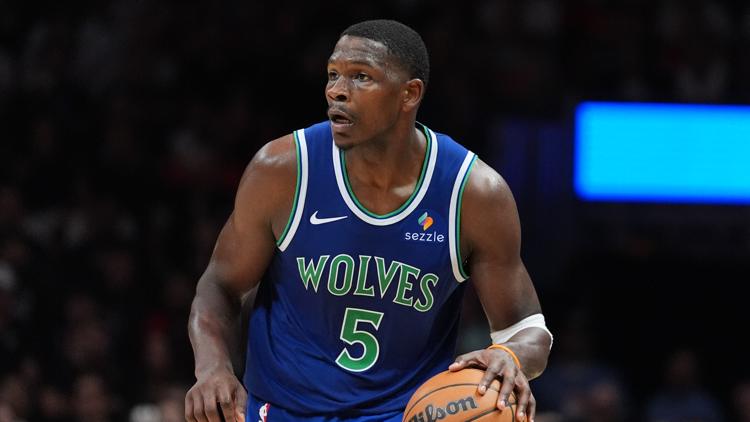 Anthony Edwards drives to the basket for the Minnesota Timberwolves, focused and determined.